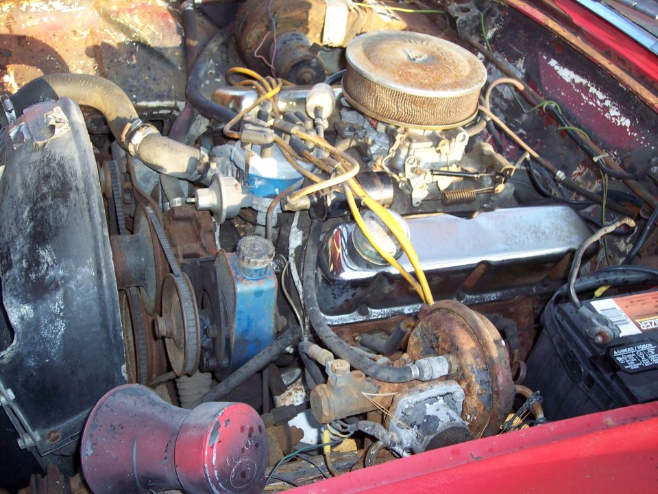 Engine bay with carburetor and air cleaner