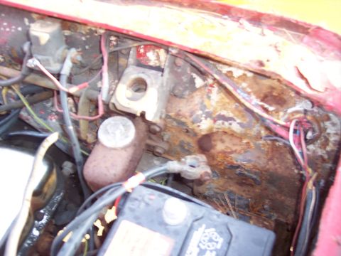 1956 Ford Thunderbird - The engine bay shows significant rust and wear on its components.
