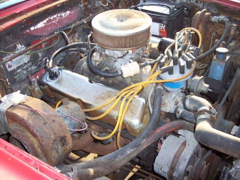 1956 Ford Thunderbird - Close-up view of a V8 engine bay, showing various components and wiring.