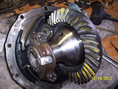 1990 Ford Bronco - Close-up of a differential gear assembly, showing the meshing of the ring and pinion gears with yellow marking compound applied.