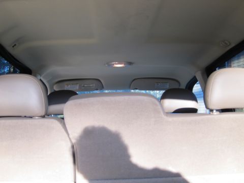 1991 Ford LTD Crown Victoria - View of the rear interior of a vehicle, including seats, headliner, and sun visors.