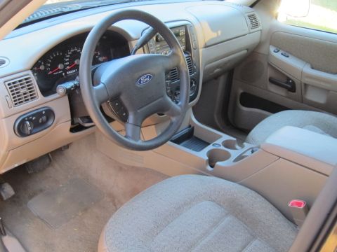 1991 Ford LTD Crown Victoria - The interior of a 2002 Ford Explorer, a tan dashboard and cloth seats.