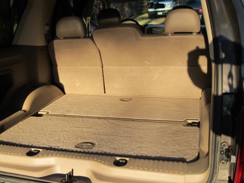 1991 Ford LTD Crown Victoria - The interior cargo area of an SUV is shown, with a second vehicle visible through the windshield.