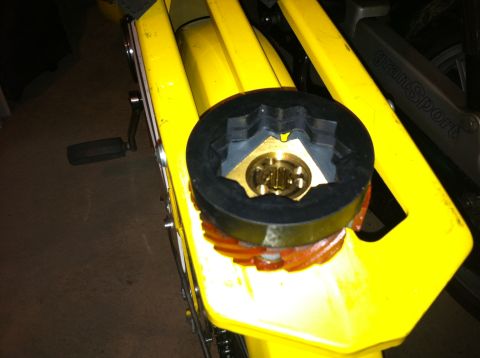 1981 Garelli Rally Sport - A specialized tool is shown engaged with the clutch mechanism of a yellow moped, with 'GranSport' visible on the frame.
