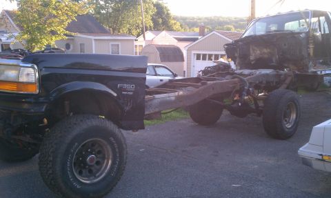 1994 Ford F-250 - Two Ford trucks, one a 1994 F-350 cab and chassis, are parked outside.