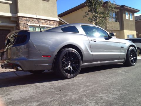 2013 Ford Mustang - Rear three-quarter view of a gray 2013 Ford Mustang with custom black wheels.