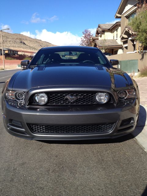 2013 Ford Mustang - Front view of a gray 2013 Ford Mustang, its distinctive grille and headlight design.