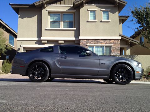 2013 Ford Mustang - A gray 2013 Ford Mustang is parked on the street in front of a modern house.