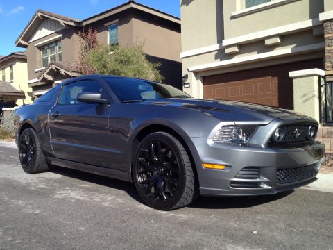 2013 Ford Mustang - A gray Ford Mustang is parked in front of a suburban house.