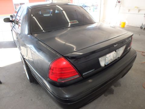2003 Ford Crown Victoria - Decklid and taillights of a dark gray Crown Victoria showing the EVIL VIC plate and trunk badge.
