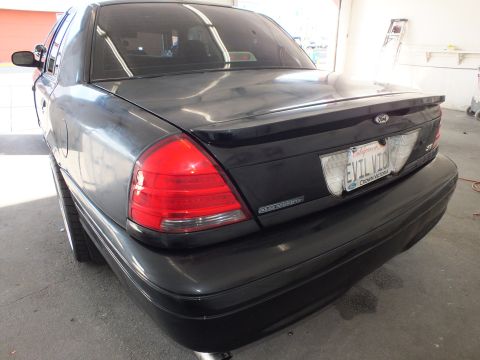 2003 Ford Crown Victoria - Decklid with Ford oval, CROWN VICTORIA badge and California EVIL VIC plate after polishing.