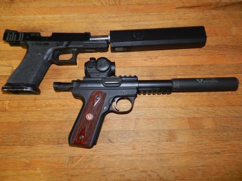 1996 Ford Bronco - Two handguns, a Glock and a Ruger Mark IV, are shown with suppressors attached.