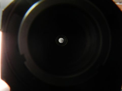 1996 Ford Bronco - A close-up view of a camera lens aperture, showing its internal mechanism and a small central opening.