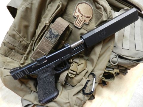 1996 Ford Bronco - Tactical pistol with suppressor and Punisher skull patch on a backpack.
