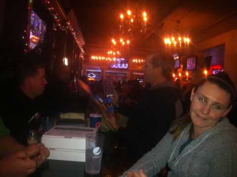 1989 Ford Bronco - People gather at a bar during a holiday party, with drinks and food on the table.