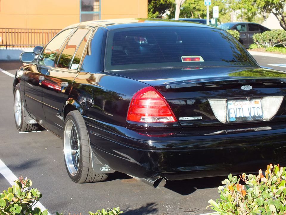 Black Ford Crown Victoria rear left with Ford oval and EVIL VTC plate