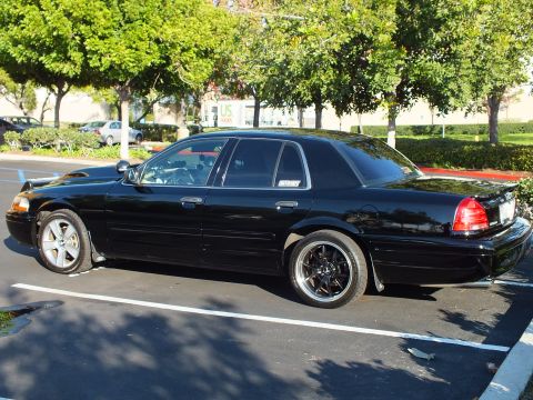 2003 Ford Crown Victoria - Side view of a lowered black Crown Victoria sedan with silver and black wheels.