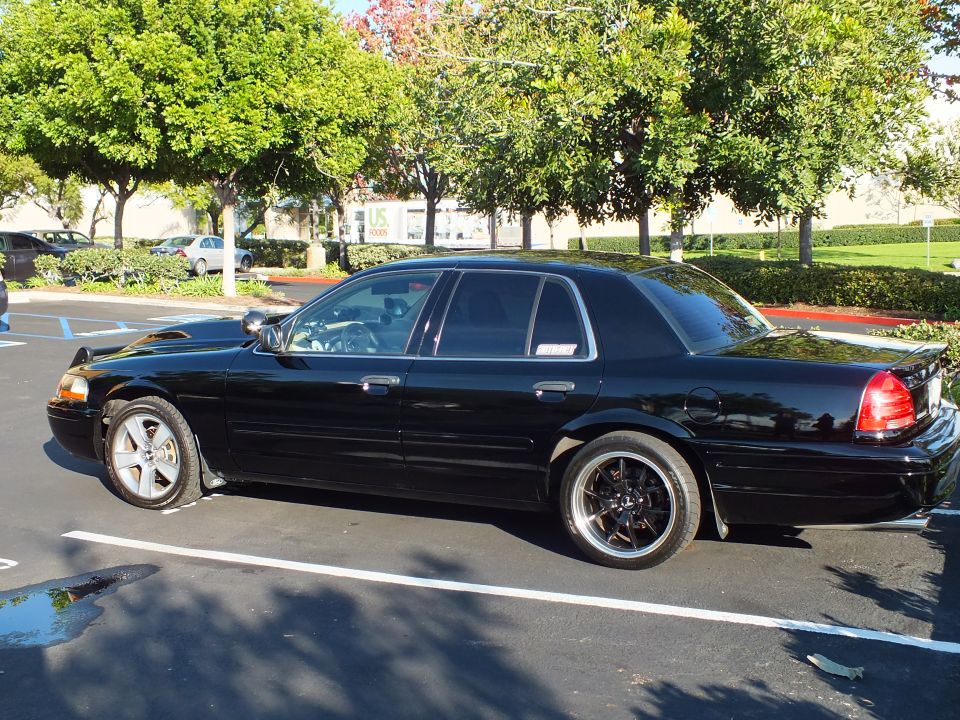 Black Ford Crown Victoria driver-side profile with red window decal