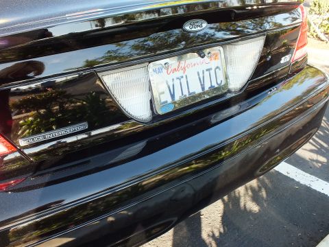 2003 Ford Crown Victoria - Close rear shot of a Ford sedan, Police Interceptor script and EVIL VIC plate in May tag.