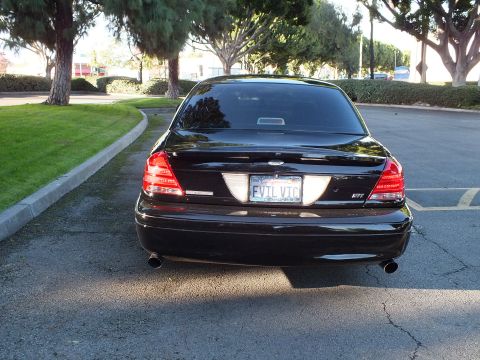 2003 Ford Crown Victoria - Straight-on rear of black Crown Victoria with EVIL VIC California plate and twin angled exhaust tips.