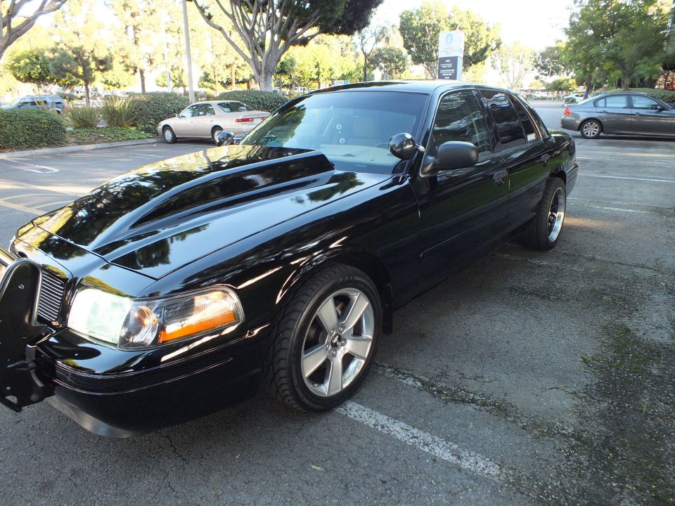 Black Ford Crown Victoria front quarter with cowl hood, billet grille, brush guard, chrome wheels