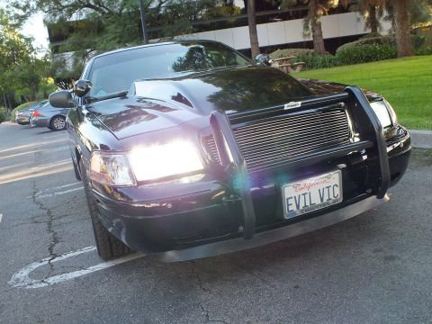2003 Ford Crown Victoria - Low front-quarter shot of black Crown Victoria, brush guard, billet grille, EVIL VIC plate at dusk.