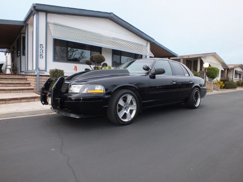 2003 Ford Crown Victoria - Lowered black Crown Victoria photographed from the front quarter with push bar fitted.