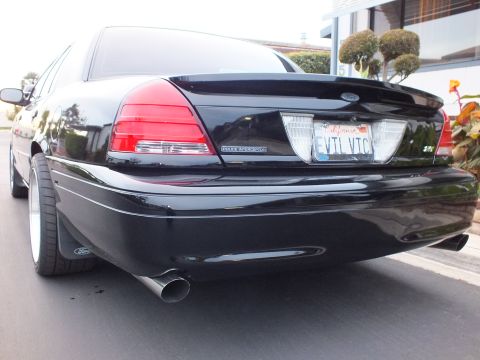 2003 Ford Crown Victoria - Low rear shot of a black Crown Victoria Police Interceptor with EVIL VIC plate and exhaust tip.