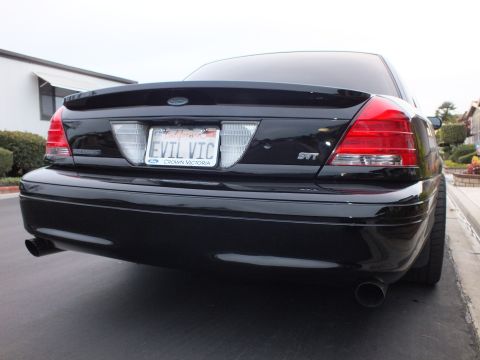 2003 Ford Crown Victoria - Rear view of a black Crown Victoria with SVT badge and dual chrome-tipped exhaust outlets.