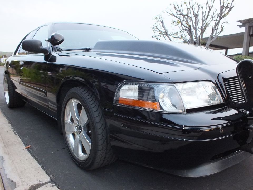 Black Ford Crown Victoria front corner, headlight, amber marker and machined wheel