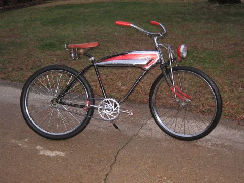 1994 Ford Bronco - A vintage-style cruiser bicycle with red handlebars and seat sits on a paved surface.