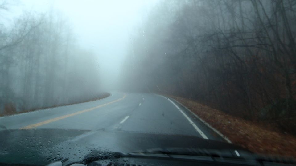 Dashboard view of a foggy road with Supermotors.net logo