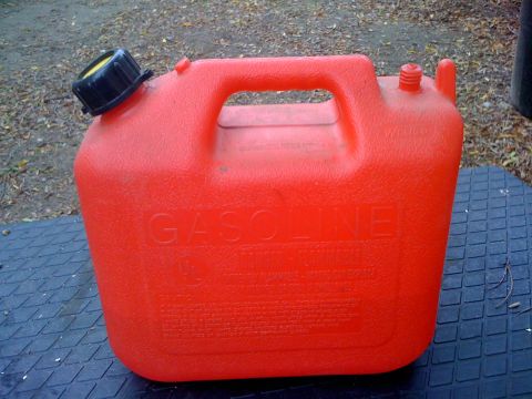1968 Ford Mustang - A red plastic gas can with a black cap is shown. The word "GASOLINE" is embossed on the side of the container.