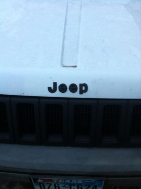1989 Ford Bronco - The Jeep logo is visible on the hood above the vertical slat grille.