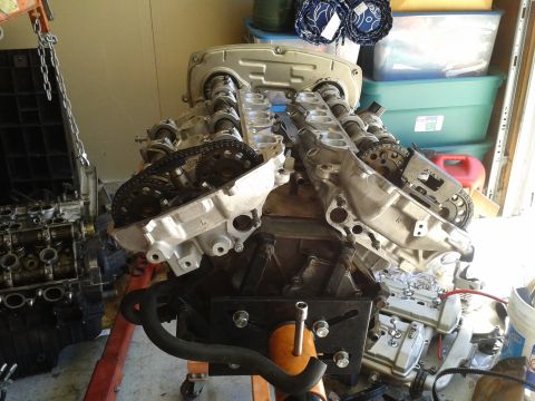 1992 Ford Taurus - This engine assembly is mounted on an engine stand, with various engine components and storage bins in the background.