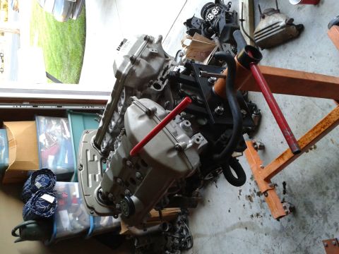 1992 Ford Taurus - An engine assembly is mounted on an engine stand, with storage bins and a window in the background.