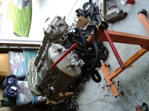 1992 Ford Taurus - An engine is mounted on an orange engine stand, ready for work or transport.