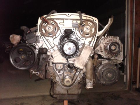 1992 Ford Taurus - Engine assembly with visible components like timing belt, pulleys, alternator, and AC compressor.