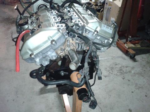 1992 Ford Taurus - Engine assembly on a stand, with visible hoses and wiring harnesses.