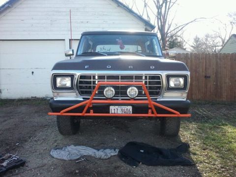 1979 Ford Bronco - This 1979 Ford Bronco features a prominent orange bull bar with auxiliary lights and a front license plate.