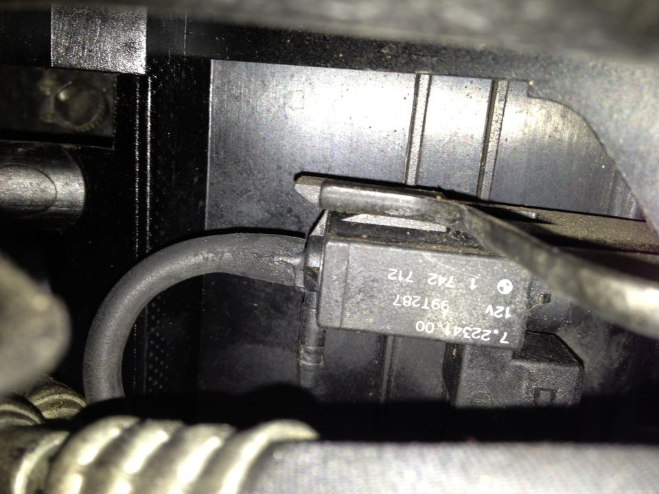 Close-up of a black electronic component with BMW logo and part numbers