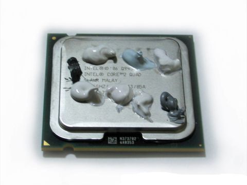 1990 Ford Bronco - A computer processor with thermal paste applied in preparation for installation.