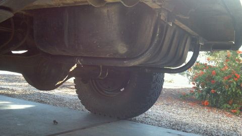 1978 Ford Bronco - Undercarriage view of a vehicle, focusing on the fuel tank and rear axle assembly.