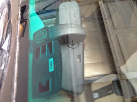 1999 BMW 5 Series - An electronic device is attached to the interior of a car's windshield, obscuring the view outside.