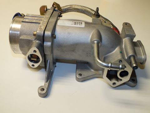 2003 Ford Crown Victoria - Side view of an aluminum intake manifold and throttle body assembly with a braided hose and cast part numbers.