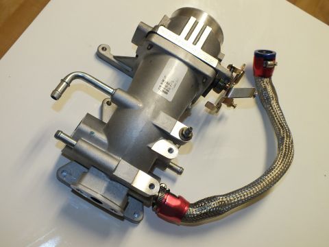 2003 Ford Crown Victoria - aluminum intake manifold and throttle body assembly with a looping braided line and red-blue anodized fittings.