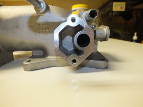 2003 Ford Crown Victoria - Close-up of a machined port flange with cast part numbers on an aluminum intake casting.
