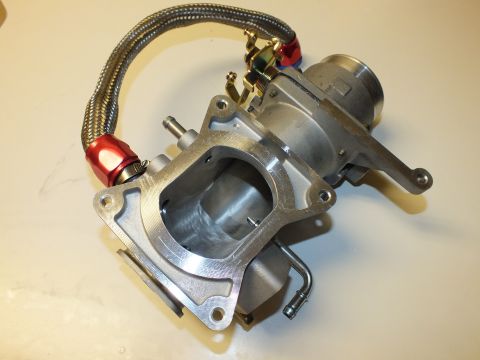 2003 Ford Crown Victoria - Angled view of a throttle body assembly with an open rectangular flange port and a braided hose with red fittings.
