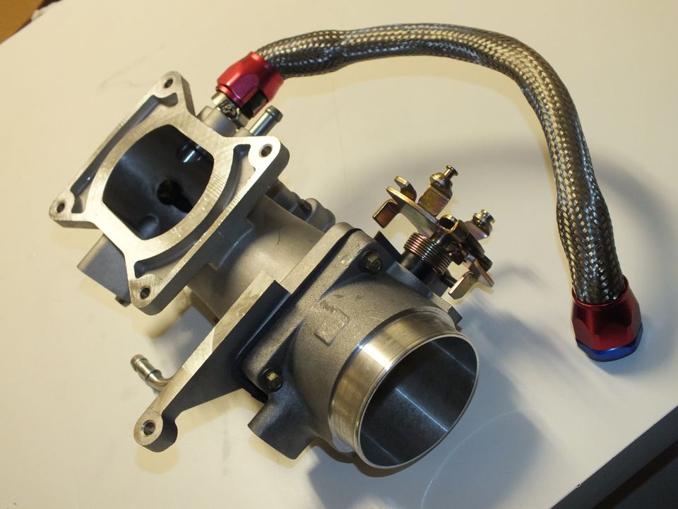 Throttle body with rectangular flange, linkage screws and braided line