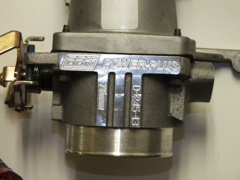 2003 Ford Crown Victoria - Macro of a BBK Power-Plus throttle body engraved 75mm and D-245-13, showing its bore and linkage.